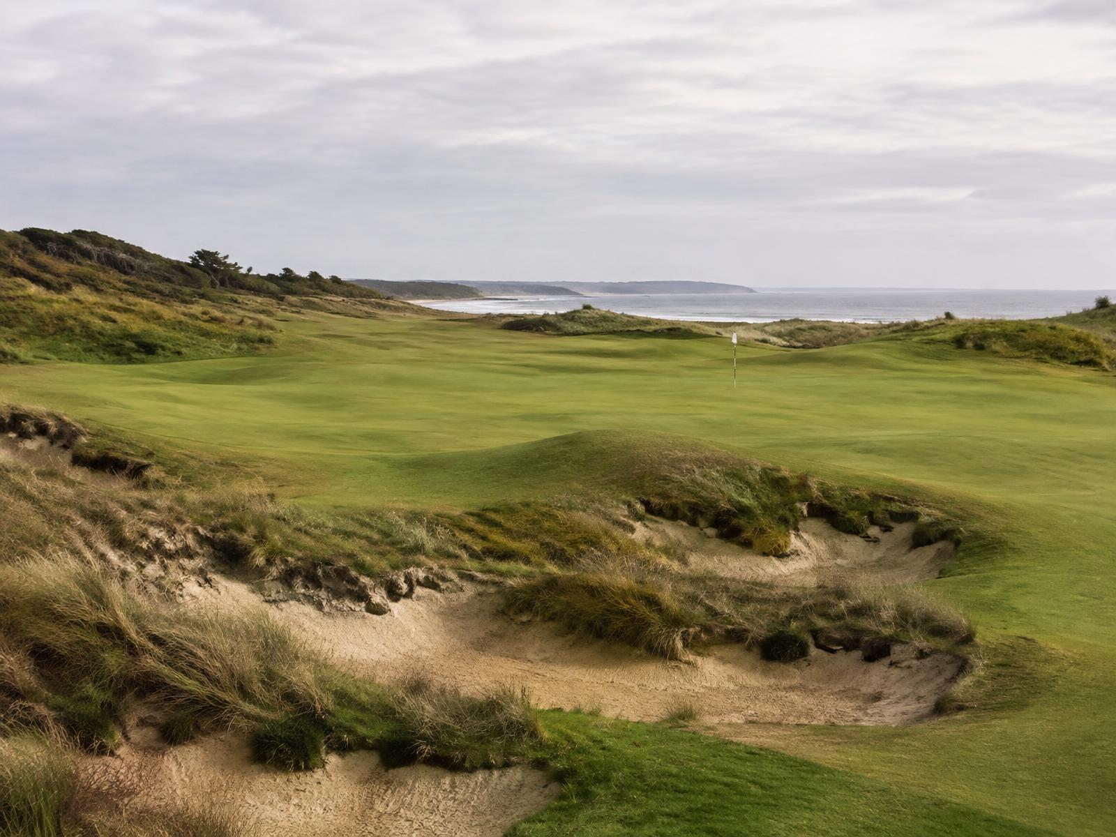 Restored classic golf hole with rugged sandy bunkers and fescue rough